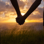 Loving couple enjoying beautiful sunset in Hawaii