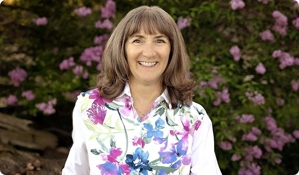 Terry Caldwell smiling wearing a flowered shirt.