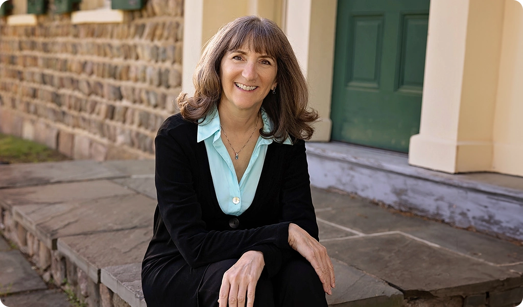 Terry Caldwell sitting on her porch relaxed and smiling.